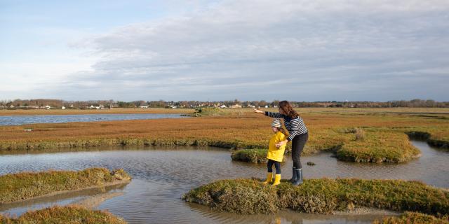 A mother and daughter stroll through the salt meadows of the havre de la Vanlée in Bricqueville-sur-Mer