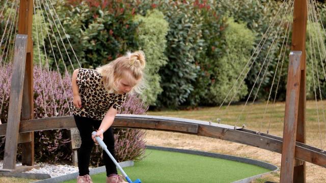 A little girl's mini-golf day at Green Mini Golf