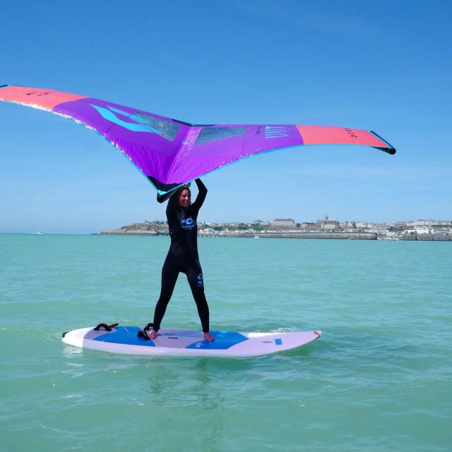 A young woman practices Wingfoil in Granville during a session for beginners