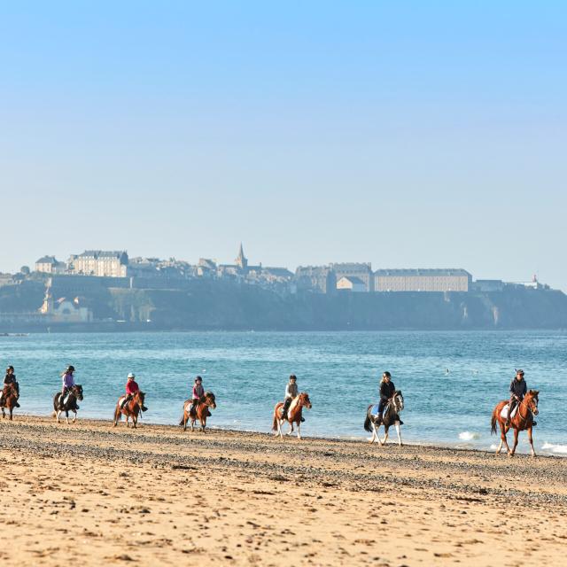 Randonneurs à cheval sur la plage